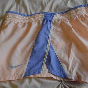 Nike Dri-Fit women's running shorts, Medium. Peach with blue mesh inset.